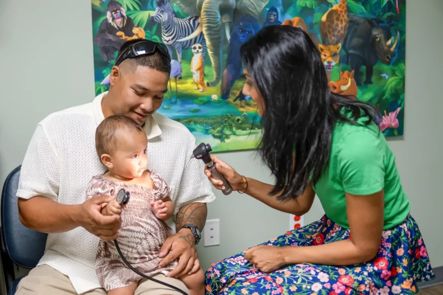doctor examining toddler